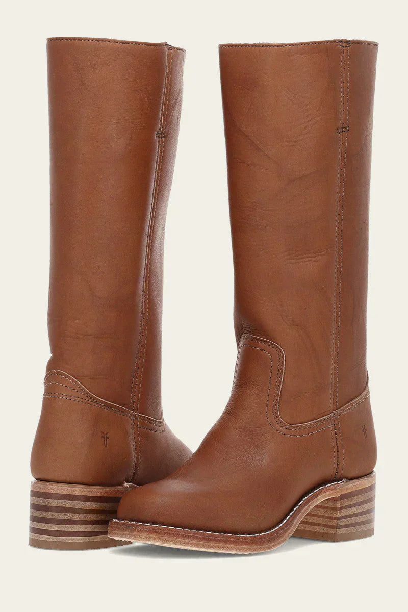 Close-up of women's leather cowboy boots, showcasing detailed embroidery and classic western heel design