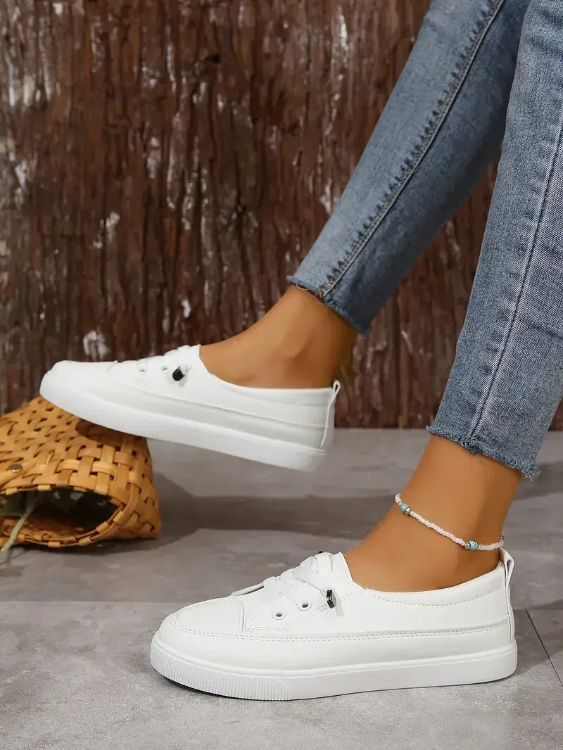 Comfortable white women's casual flats with round toe and lace-up design, great for everyday walking.
