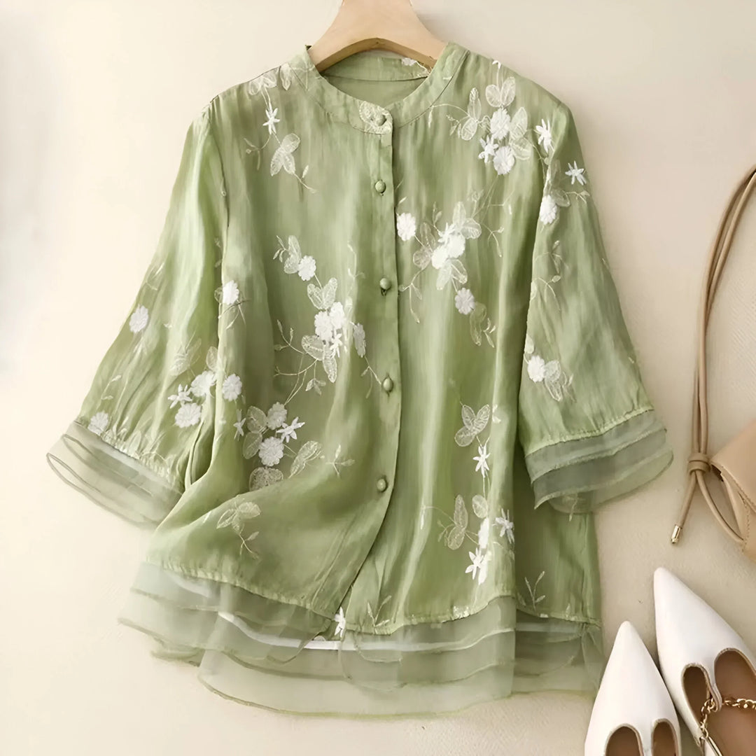 White cotton women's top with elegant floral embroidery, a comfortable summer fashion choice