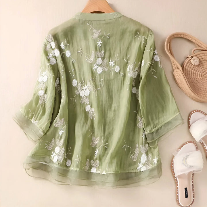 Casual women's short-sleeve white cotton top with subtle floral embroidery, everyday wear