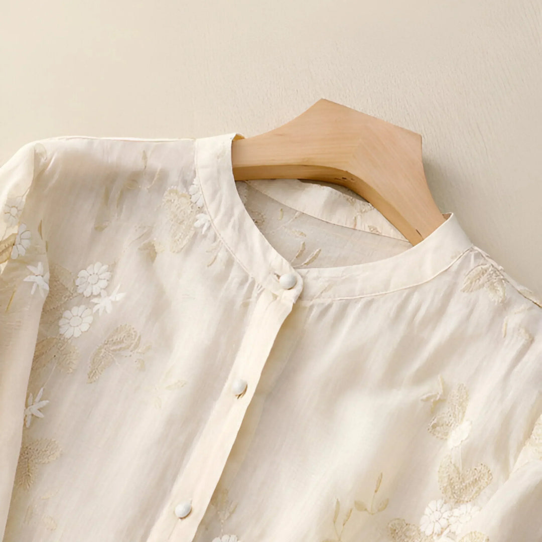 Relaxed fit white cotton blouse for women featuring delicate floral embroidery detail