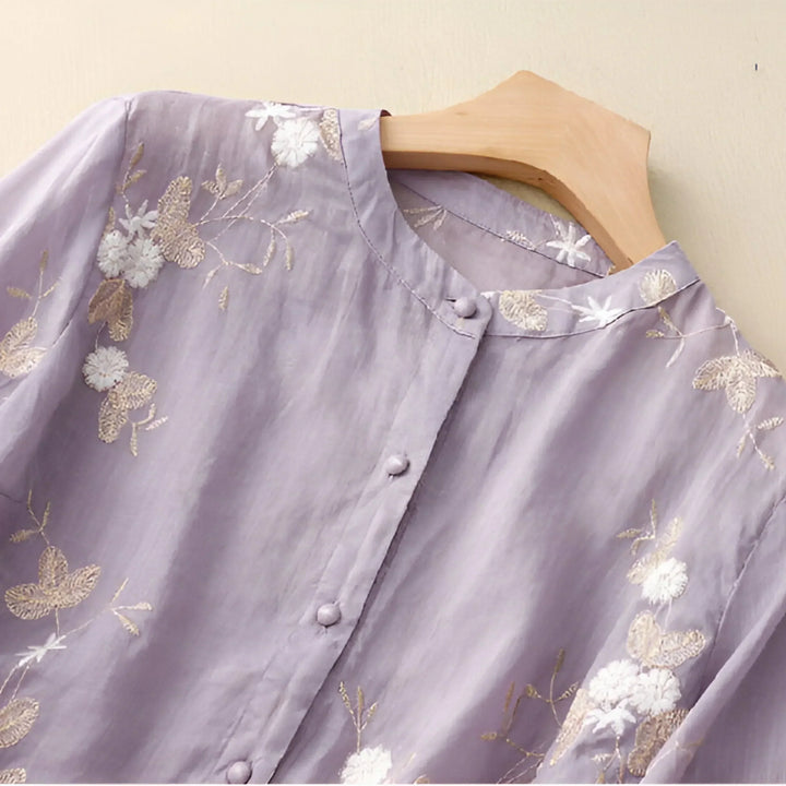Side view of a white cotton floral embroidered women's top, relaxed fit blouse