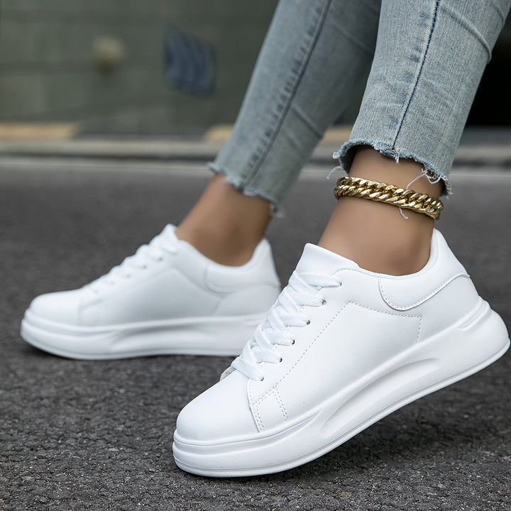 Women's white leather lace-up sneakers, combining casual comfort with a chic versatile design.