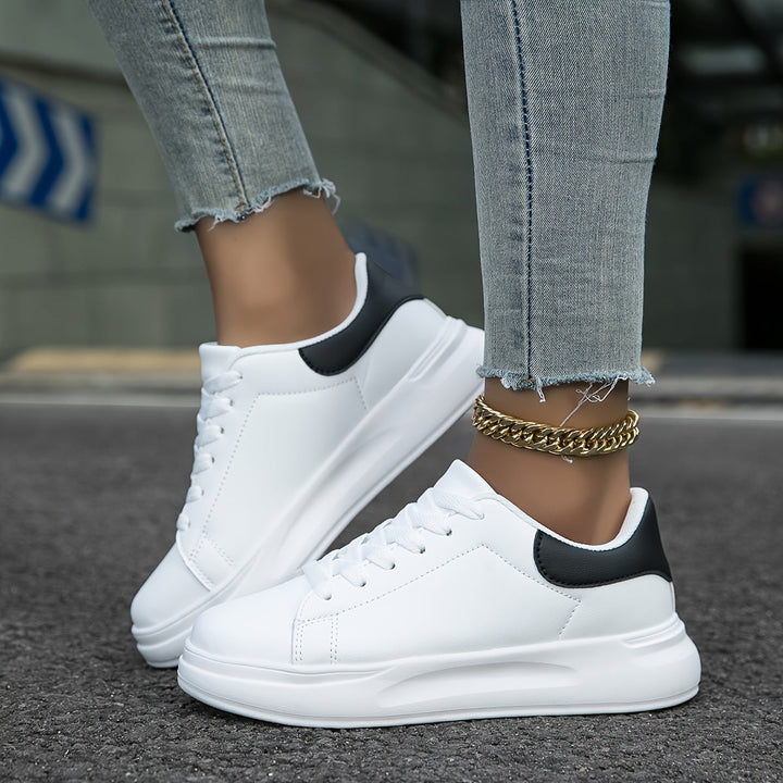 Versatile white leather sneakers for women, new collection, featuring a minimalist design.