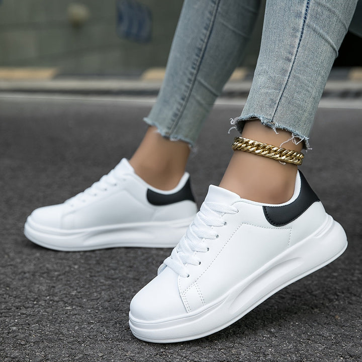 Side view of new women's white leather casual shoes, ideal for spring fashion outfits.