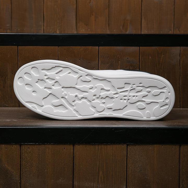Pair of white leather women's sneakers on a clean background, highlighting their fresh new look.
