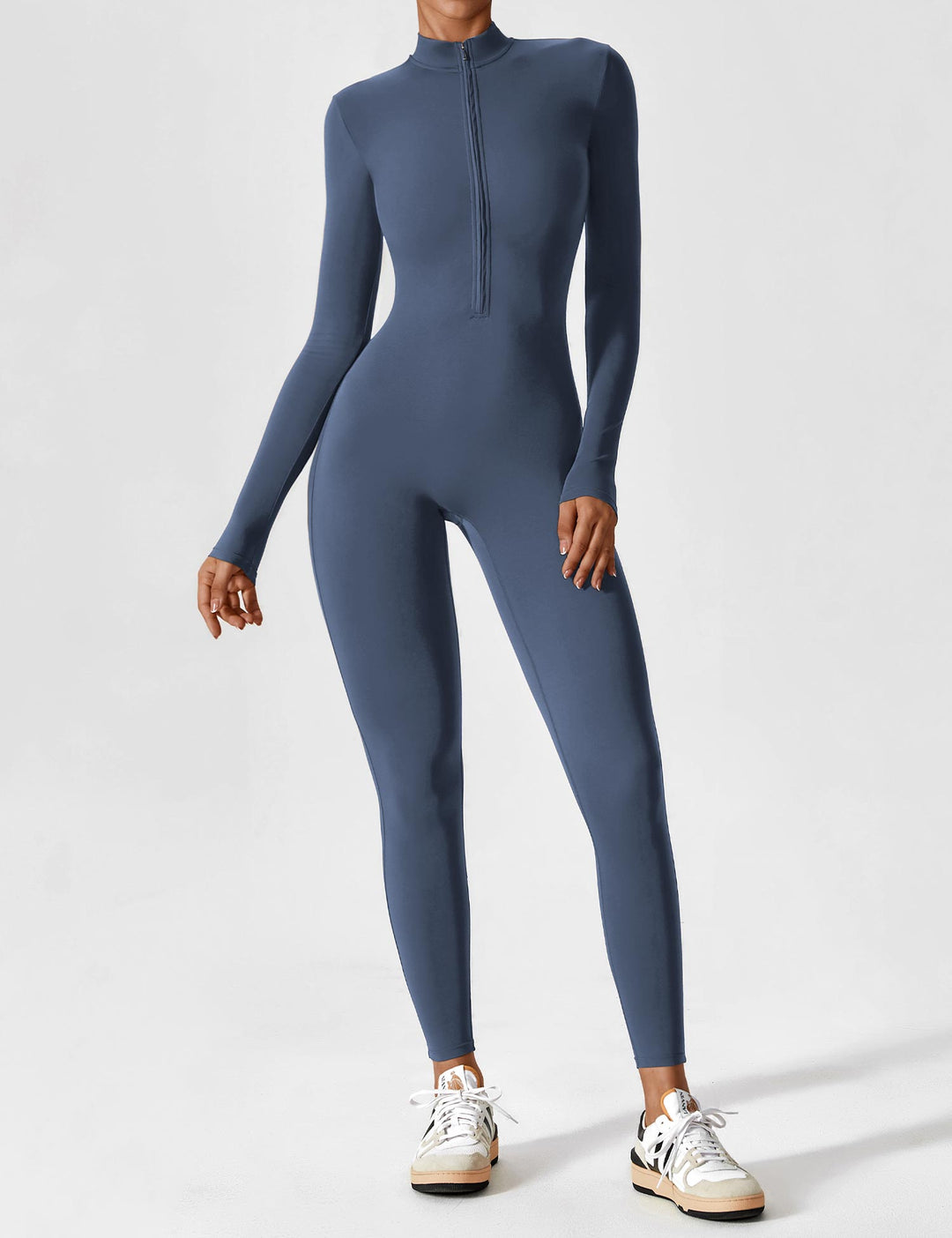 Woman extending arms in a white long sleeve zip lounge set, freedom of movement