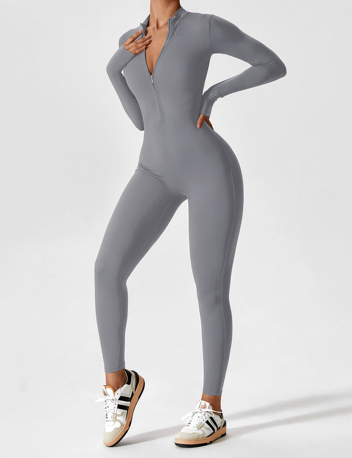 Woman on her phone in a white long sleeve zip lounge set, modern casual look