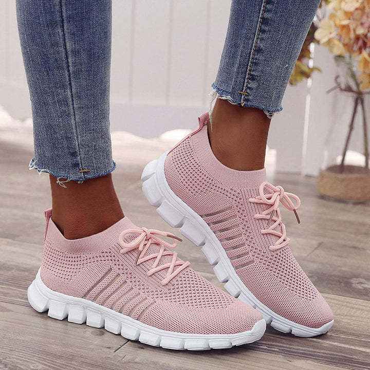 Women's white orthopedic balance sneakers, breathable and lightweight, for comfortable walking.