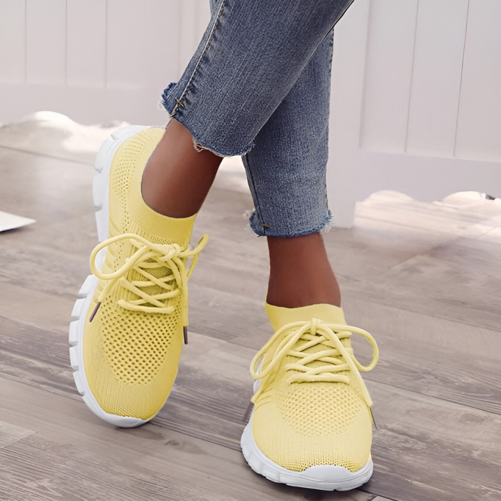 Women's white orthopedic walking shoes with a balanced design, ensuring supportive comfort.