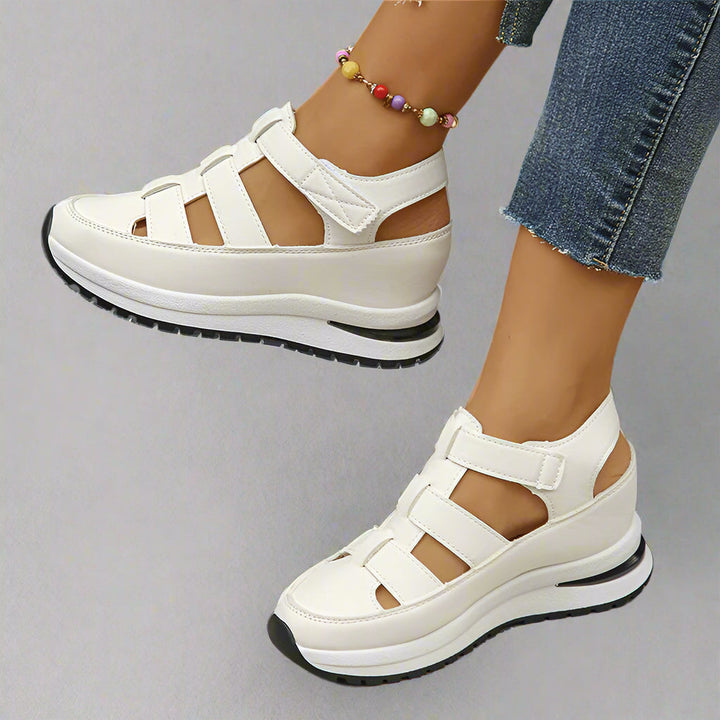 Women's white platform sneakers with cutout detailing, perfect for stylish spring and summer casual wear.