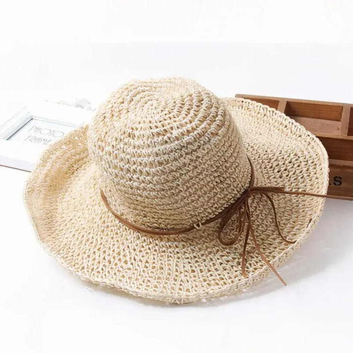 Stylish woven straw hat for women, featuring a wide brim, ideal for summer beach fashion & sun.