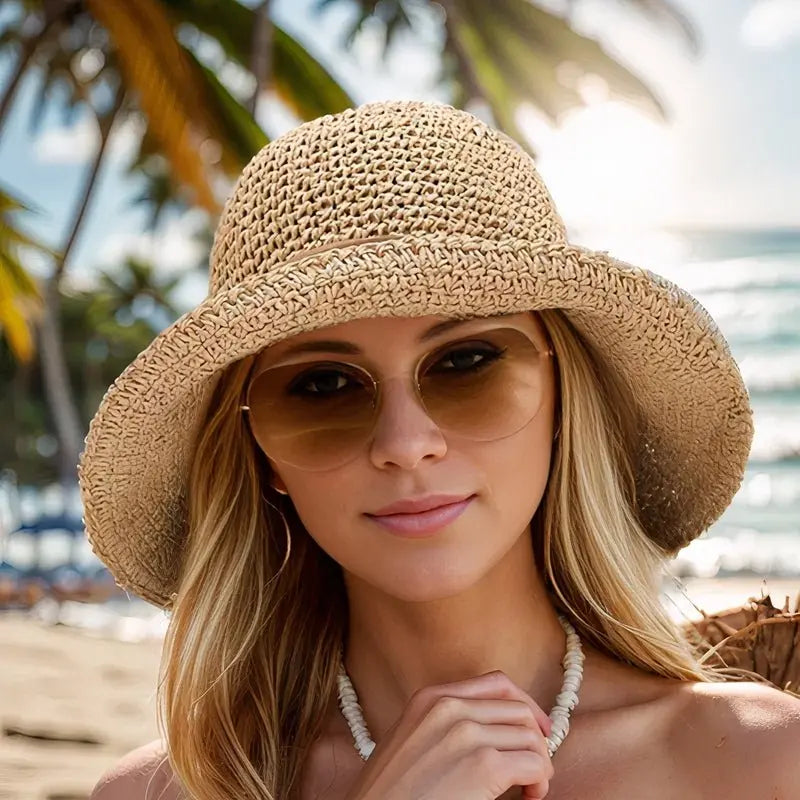 Elegant women's wide brim straw hat offers excellent UV protection for summer holidays & beach trips.