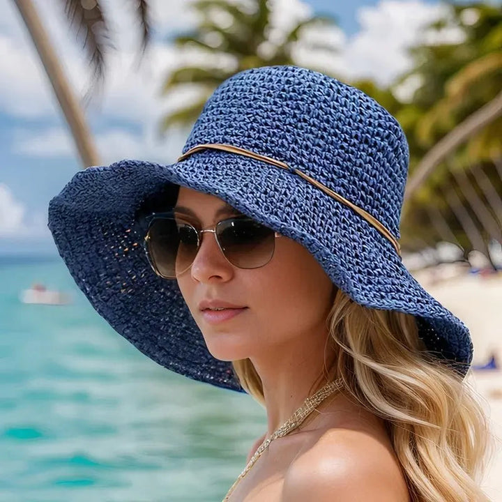 Classic women's wide brim straw sun hat in natural tone, great for summer fashion, beach, and sun safety.