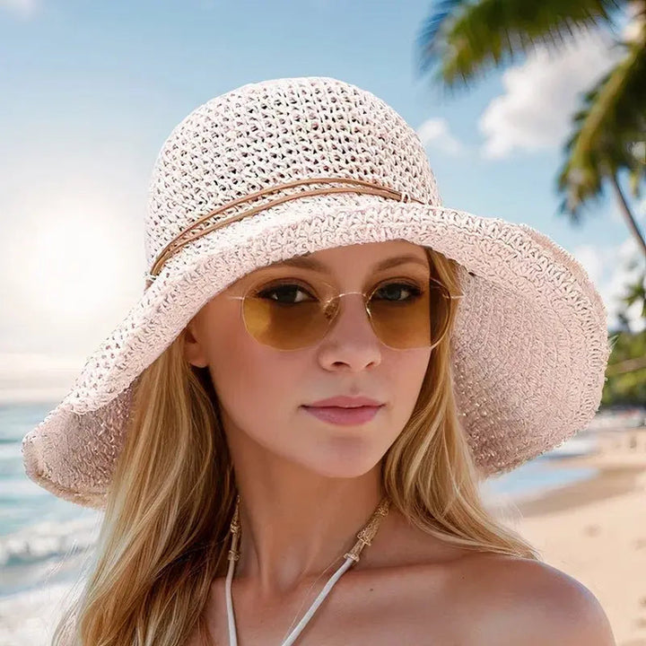 Essential women's wide brim straw hat, a chic summer beach accessory providing UV sun protection.