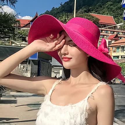 Stylish wide brim straw sun hat for women, offering excellent UV protection for beach days & summer.