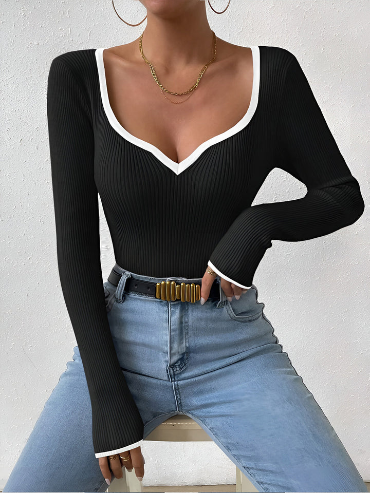 Warm women's knit sweater with sophisticated contrast trim, a cozy winter fashion essential