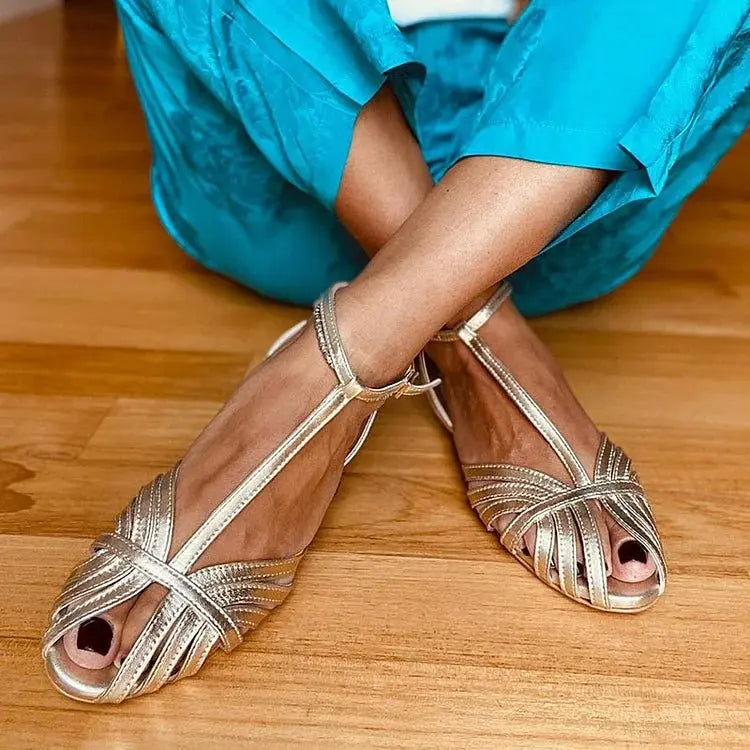 Women's shimmering metallic T-strap sandals with peep toe, perfect for elegant evening parties & summer comfort.