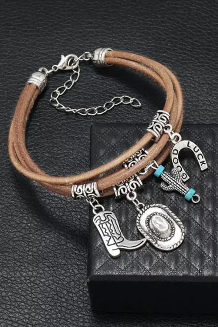 Silver women's western charm bracelet. Multi-layered design with detailed hat and boot charms. Cowgirl fashion.