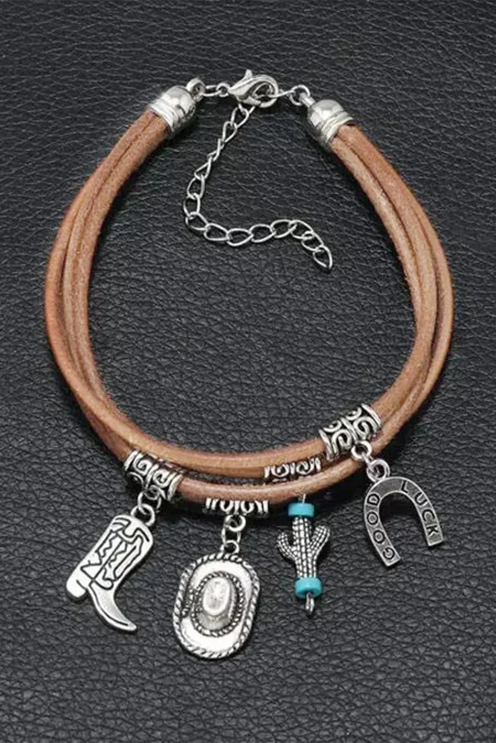Fashionable layered silver western charm bracelet for women, featuring intricate hat and boot charms.
