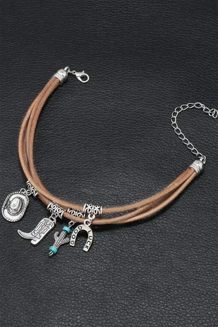 Stylish women's multi-layered western bracelet. Silver charms include a cowboy hat and boot. Cowgirl jewelry.