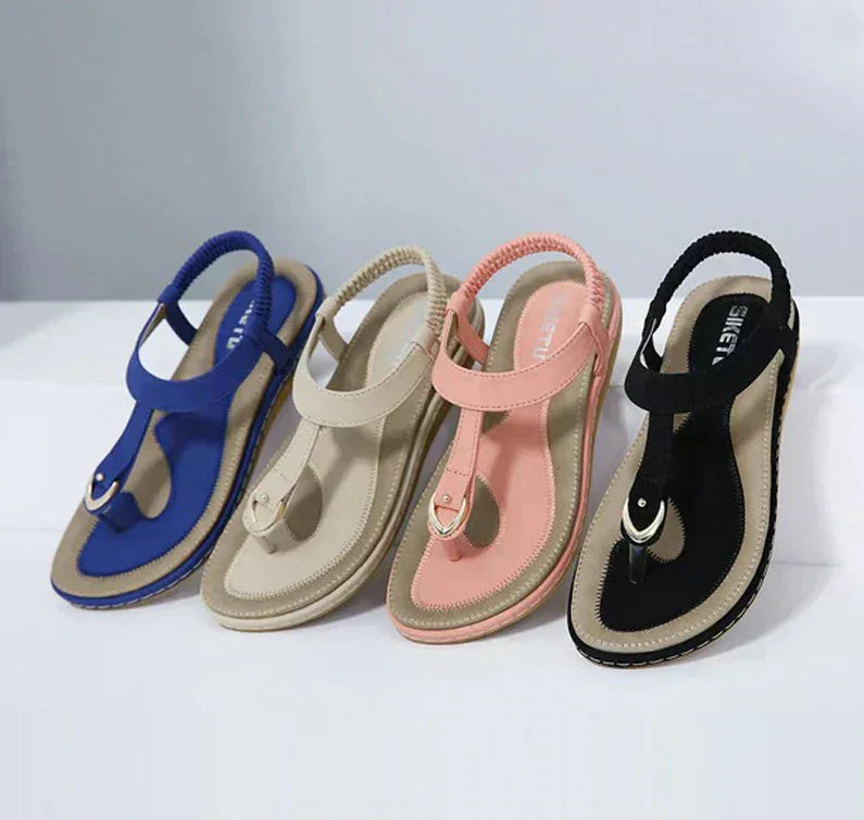 Women's orthopedic flat T-strap sandals with arch support for comfortable summer walking and foot pain relief.