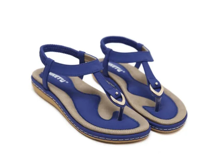 Women's T-strap sandals with elastic ankle straps, flat sole, and orthopedic arch support for ultimate comfort.
