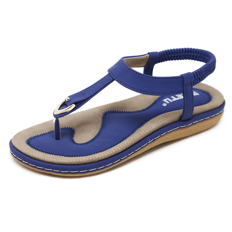 Stylish women's flat T-strap sandals featuring elastic strap & orthopedic arch support for summer comfort.