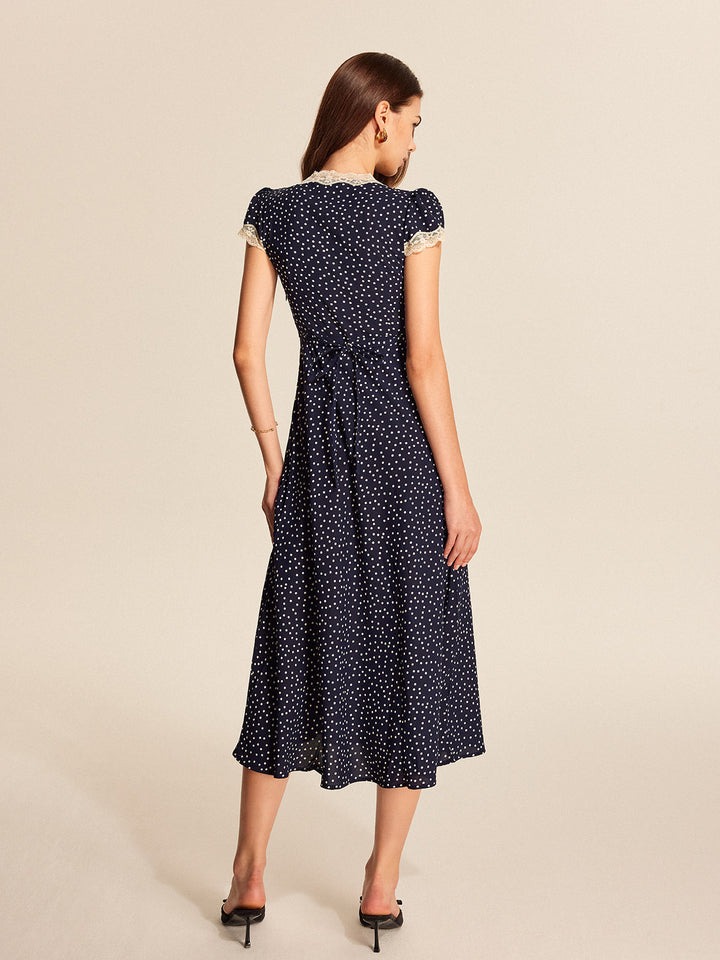 Flowy polka dot maxi dress for women, featuring a V-neck and delicate lace trim. Perfect summer look.