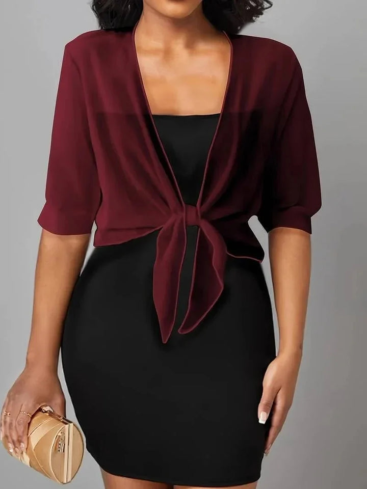 Unique tie-front design on this sheer women's 3/4 sleeve blouse, modern and chic fashion.