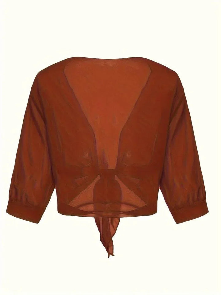 Elegant women's sheer tie-front top with 3/4 sleeves, a fashionable and versatile layering piece.