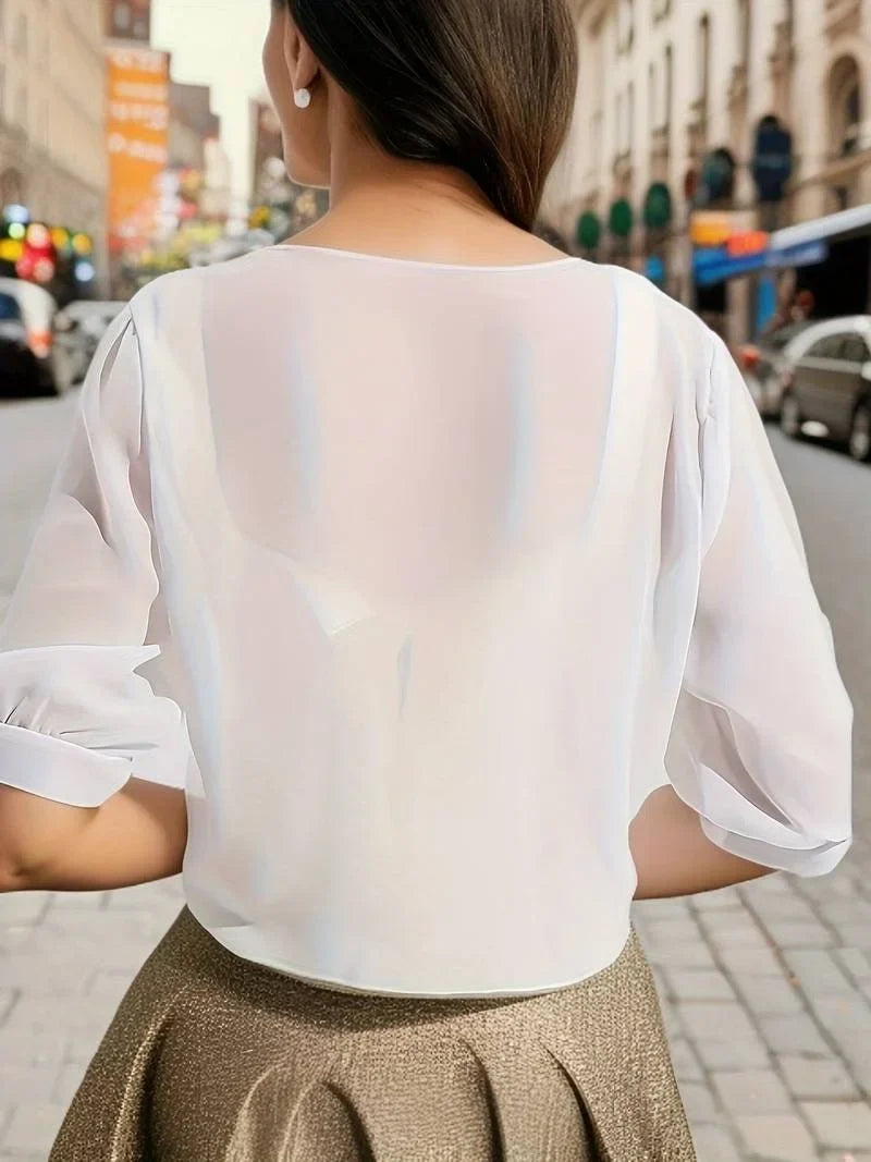 Sheer women's blouse with elegant tie-front and comfortable 3/4 sleeves; a must-have fashion top.