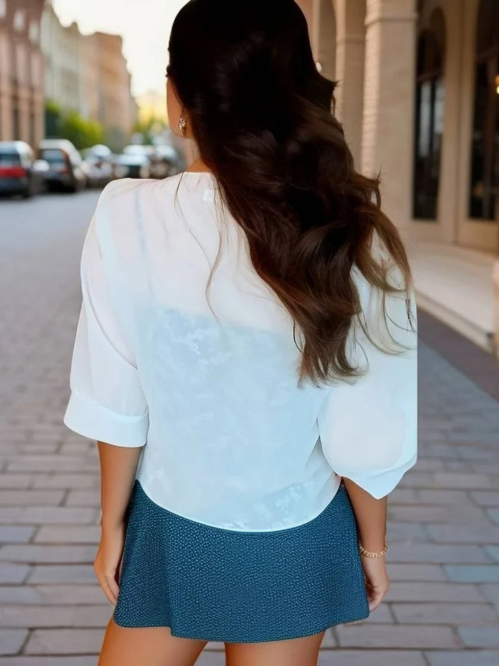 Resort wear women's sheer blouse, 3/4 sleeve, tie-front closure, perfect for warm weather.