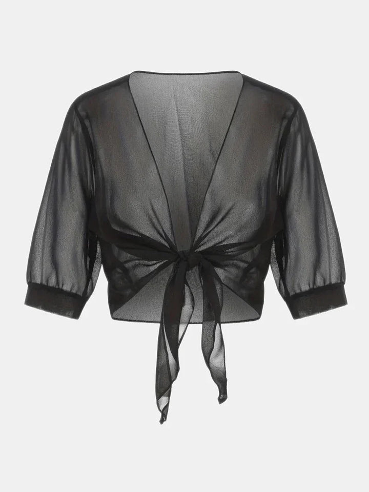 Chic women's sheer blouse featuring a tie-front closure and comfy 3/4 length sleeves.
