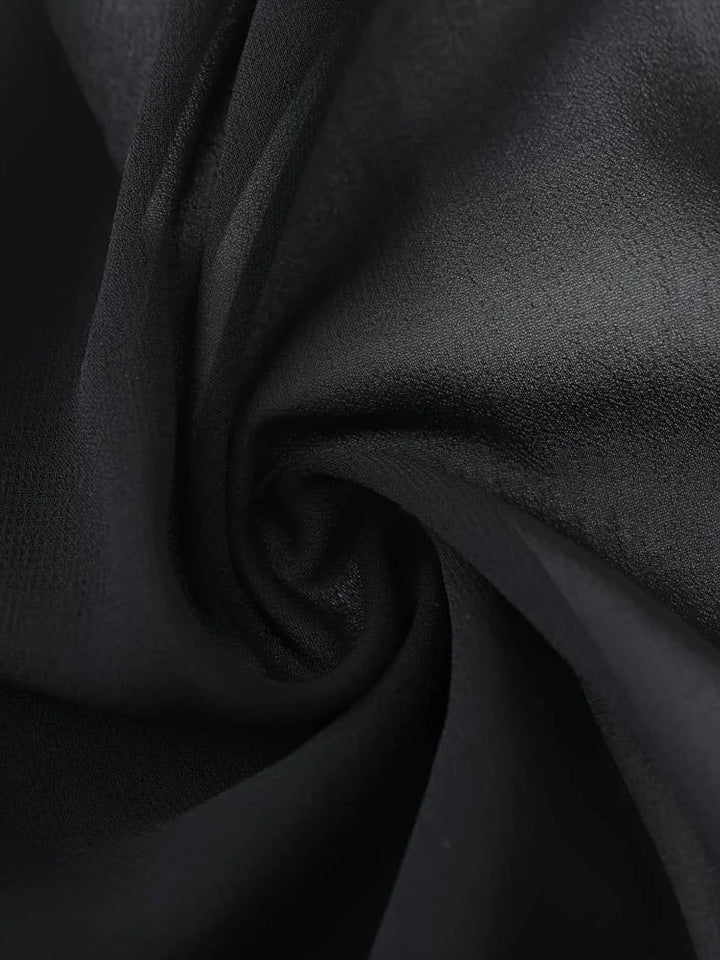 Women's sheer 3/4 sleeve top with tie front, ideal for elegant layering in warm seasons.