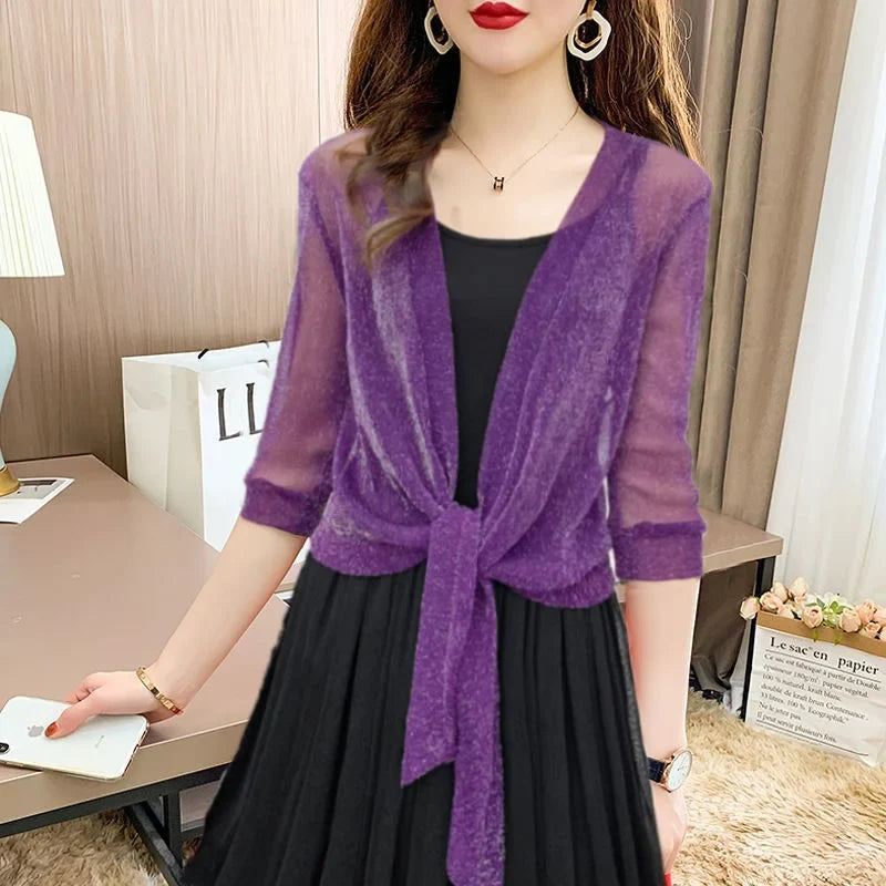Lightweight sheer women's blouse featuring a front tie and 3/4 sleeves; a chic summer top.