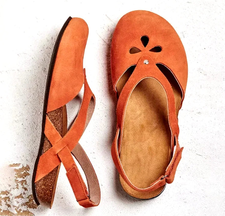 Casual women's slingback sandals, designed with a chic closed toe and intricate floral laser-cut detailing.