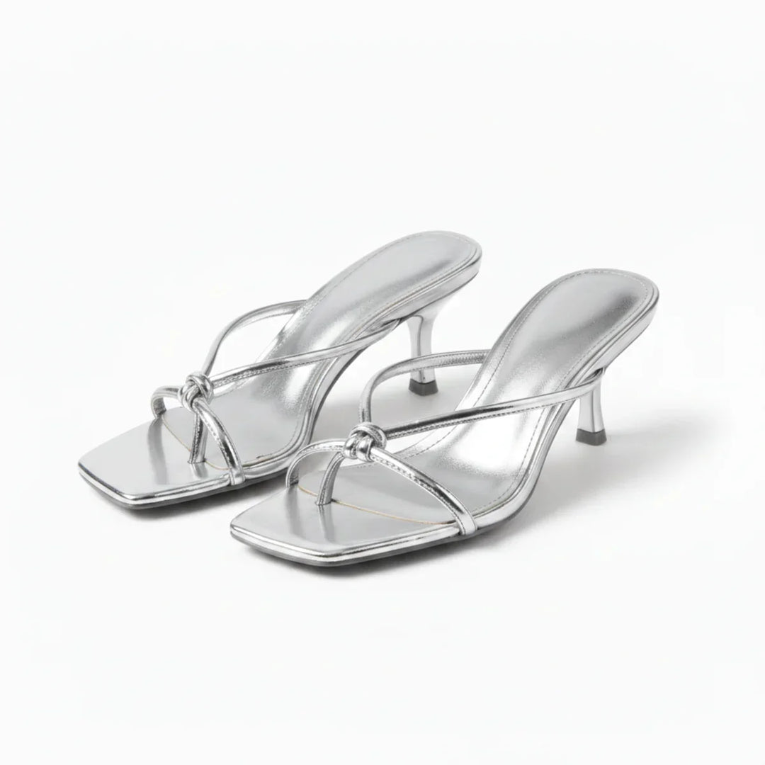 Chic women's heeled sandals with unique knot detail, perfect for sophisticated summer footwear & parties.
