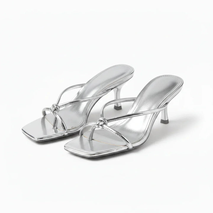 Chic women's heeled sandals with unique knot detail, perfect for sophisticated summer footwear & parties.